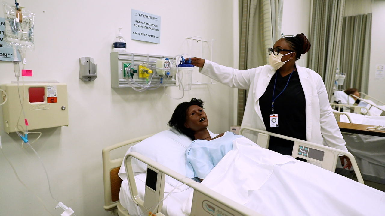 Healthcare worker assists patient in hospital room
